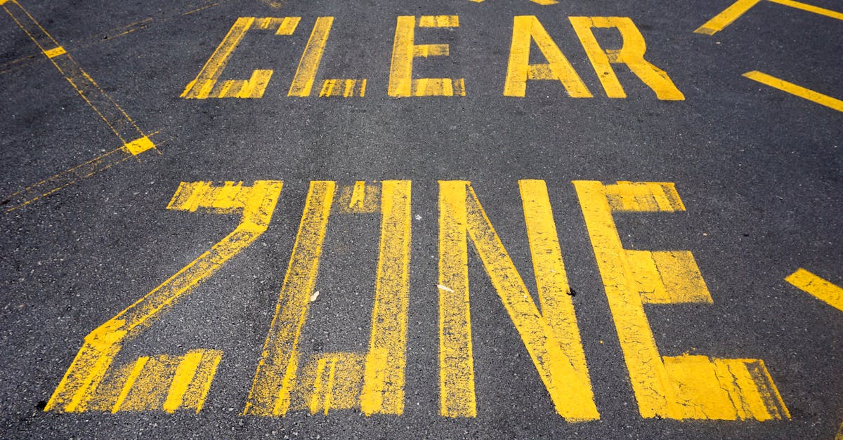 Close-up view of 'Clear Zone' road markings painted in yellow on asphalt in New Zealand.
