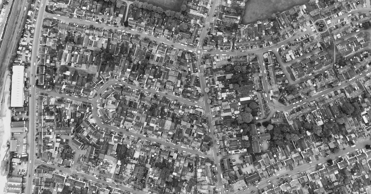 Aerial monochrome photograph of Luton's urban layout, showcasing city streets and architecture.