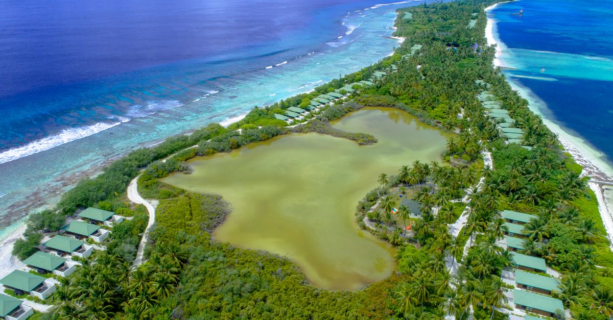 Stunning aerial view of Addu City, Maldives, showcasing lush greenery and pristine waters.