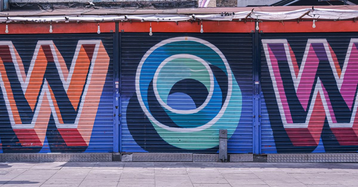 Vivid street art with bold letters on roller shutters in London, England.