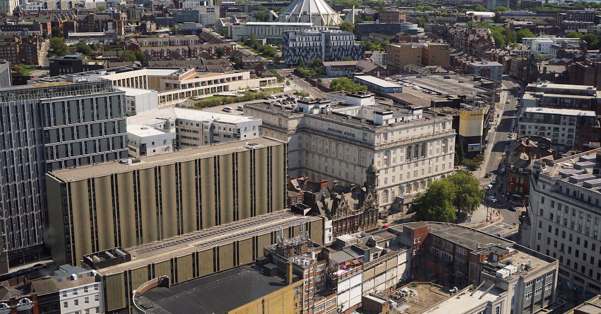 Aerial cityscape featuring a mix of modern and historic architecture, with prominent landmarks visible.