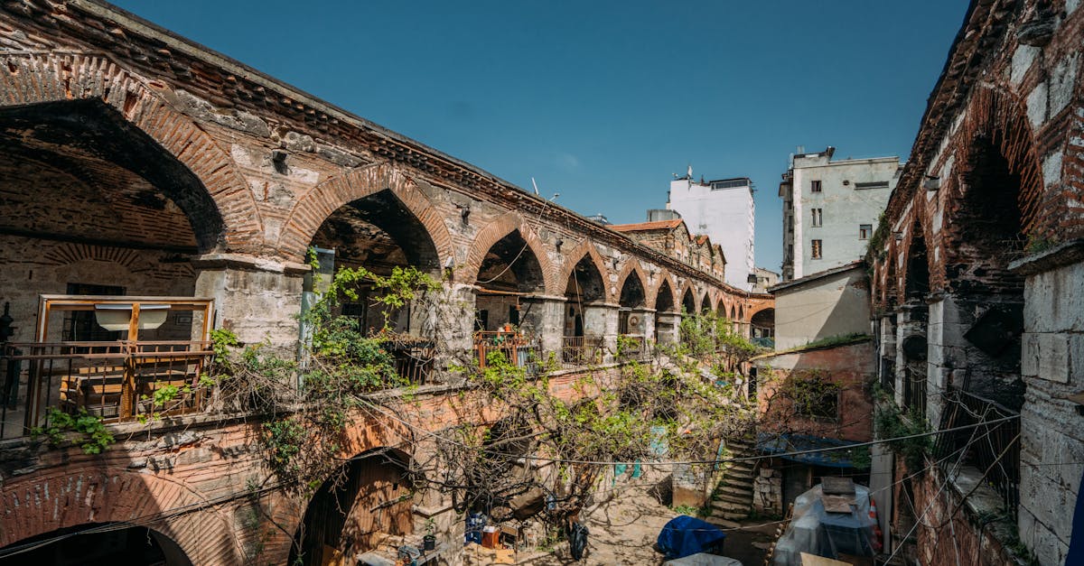 Ancient brick colonnades with vines showcase urban decay in a historic city courtyard.