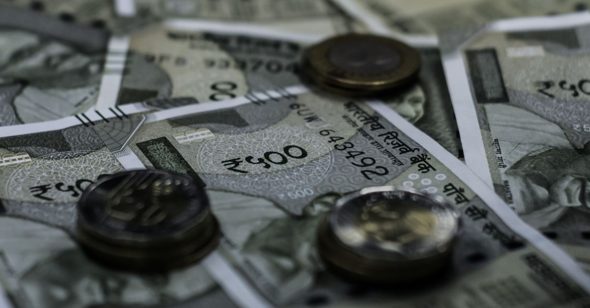 Detailed view of Indian currency notes and coins representing wealth and finance.