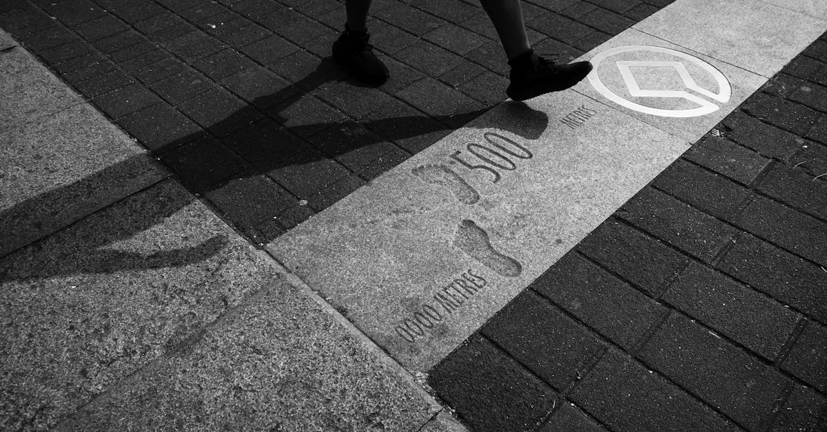 Silhouette of a man walking on a sidewalk crossing, marked with distance and symbols.