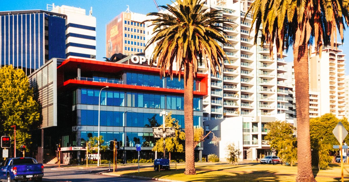 Colorful urban street view in Perth, Australia with palm trees. Captures city life and architecture.