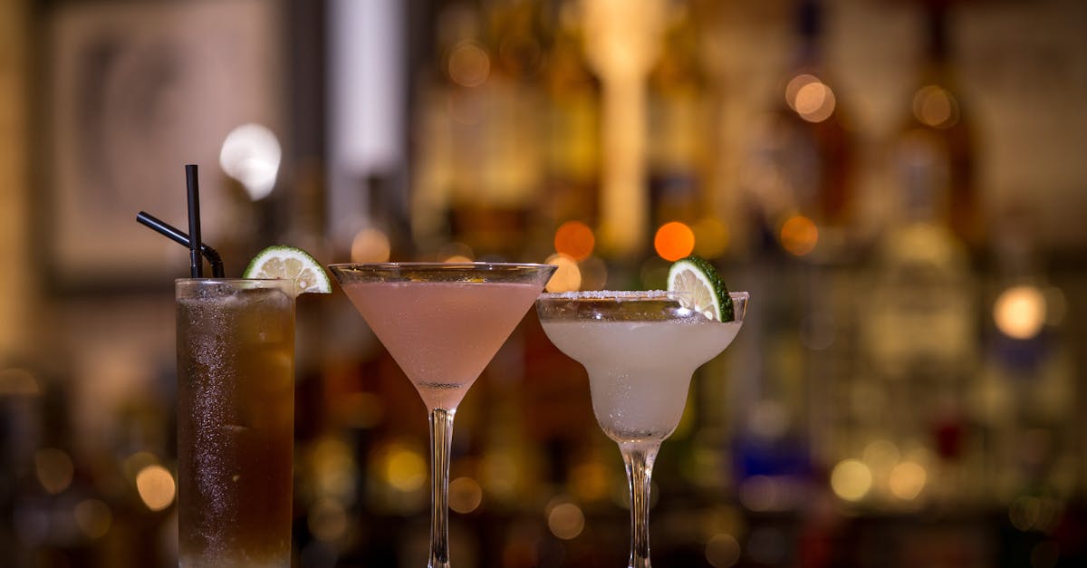 Three colorful cocktails on a bar, perfect for a night out with friends.
