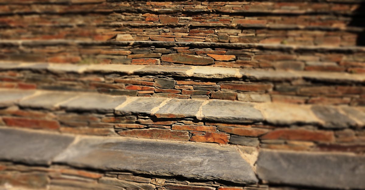 Close-up of a textured stone staircase with a rustic and symmetrical design. Ideal for backgrounds.