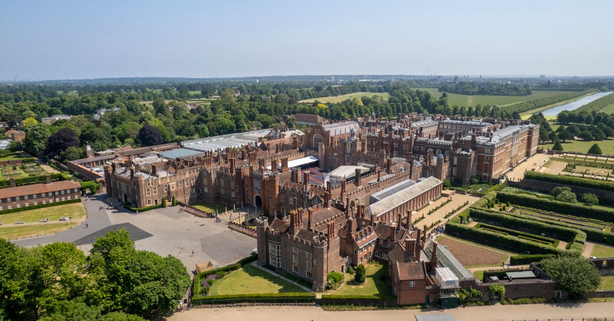 Stunning aerial view of Hampton Court Palace, showcasing its historical architecture and vast gardens.