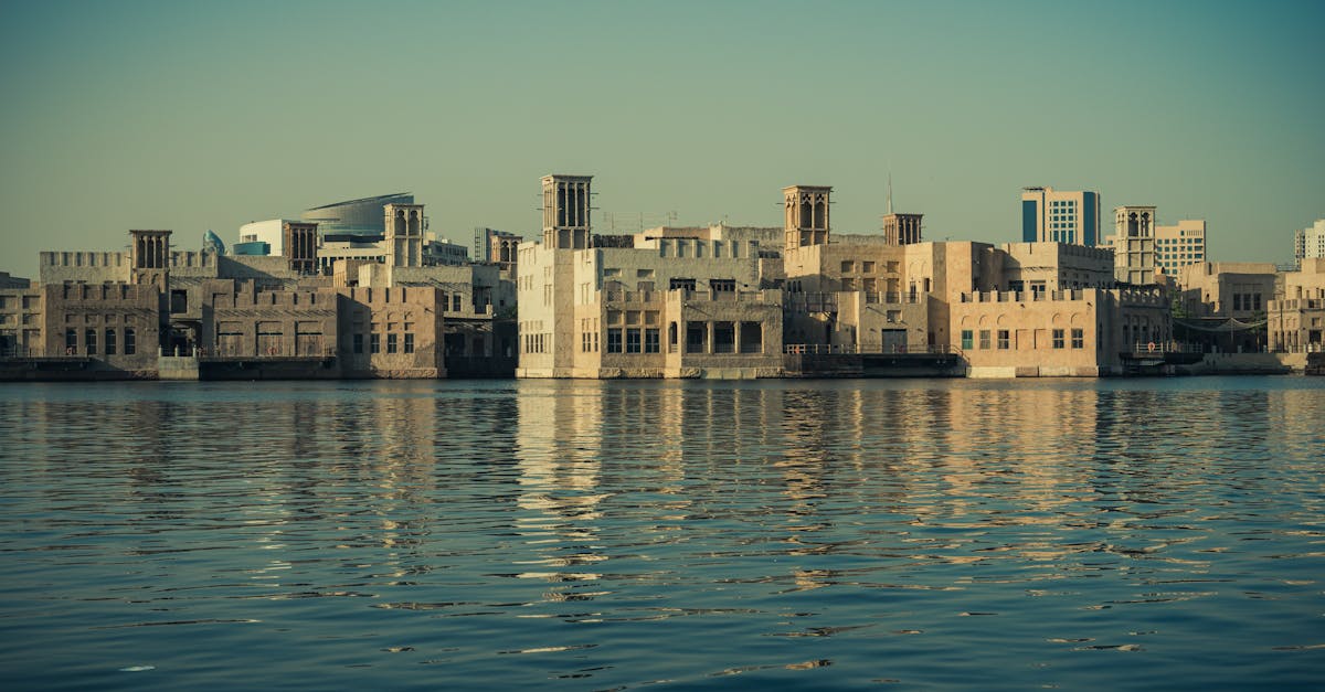 Scenic view of modern architecture reflecting on the Dubai Creek waters, showcasing Dubai's waterfront skyline.