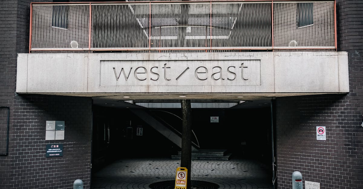 A modern urban entrance displaying 'west/east' with architectural details and clear signage.