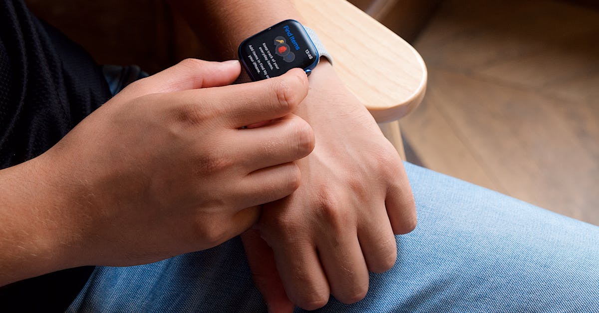 Close-up of a person interacting with a smartwatch, showcasing modern technology and portability.