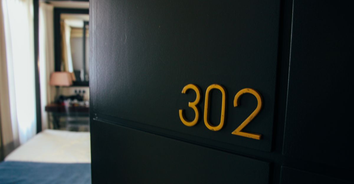 Stylish hotel room with room number 302 and elegant interior design.