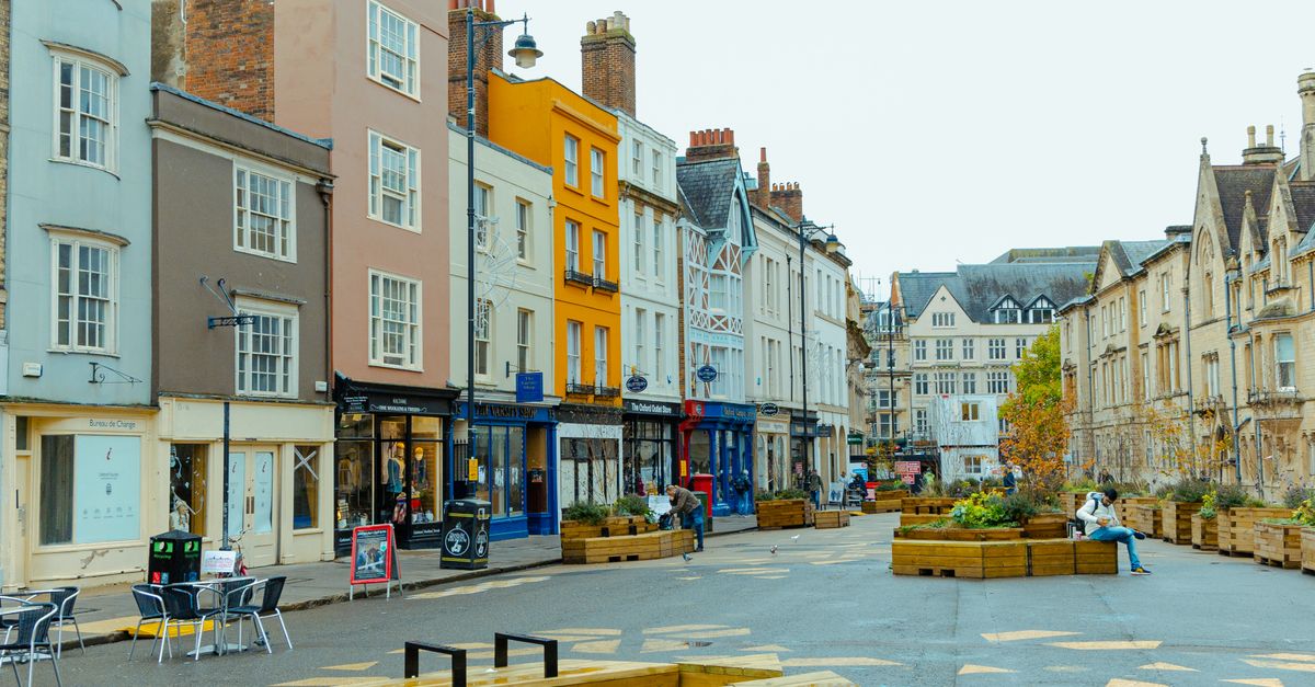 Colorful urban scene in Oxford, England, showcasing charming architecture and street life.