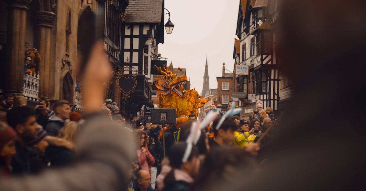 Vibrant festival parade with golden dragon in Chester, England.