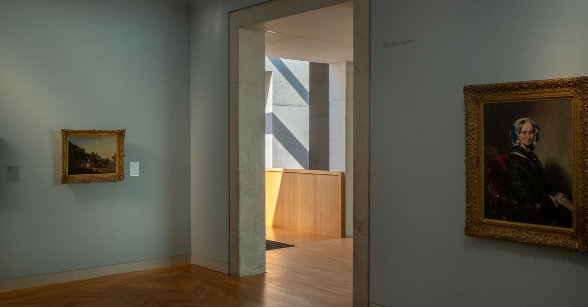 A well-lit museum room displaying classic framed paintings with a wooden floor.
