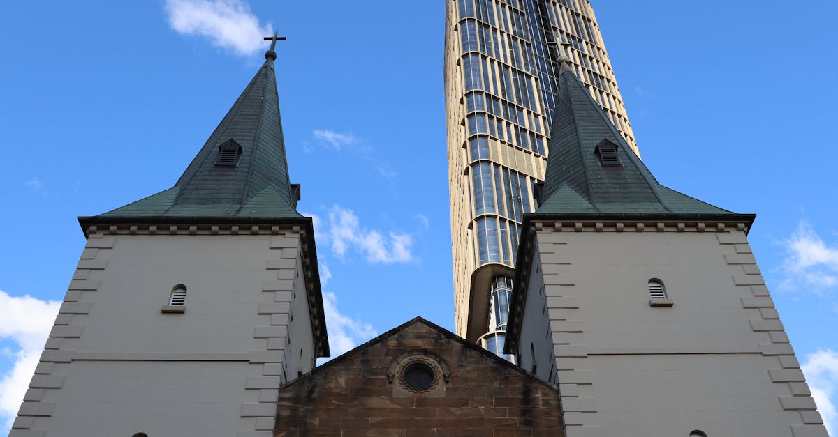 An iconic view of a historic church juxtaposed against a modern skyscraper in Parramatta, Australia.