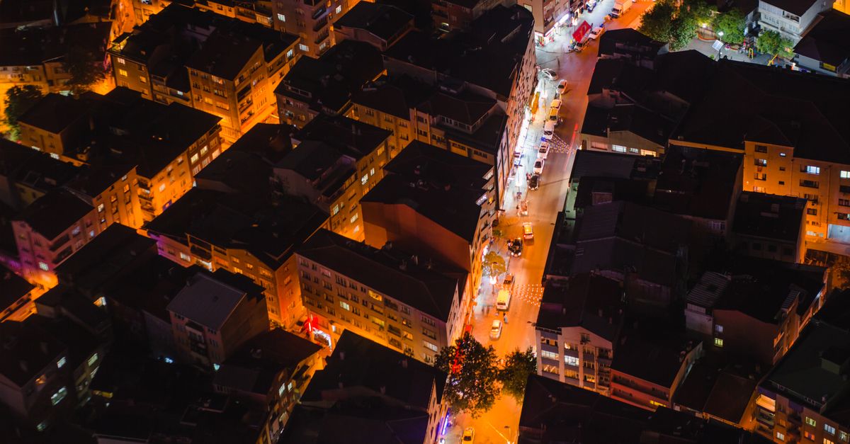A vibrant aerial view of illuminated Istanbul streets and rooftops at night.