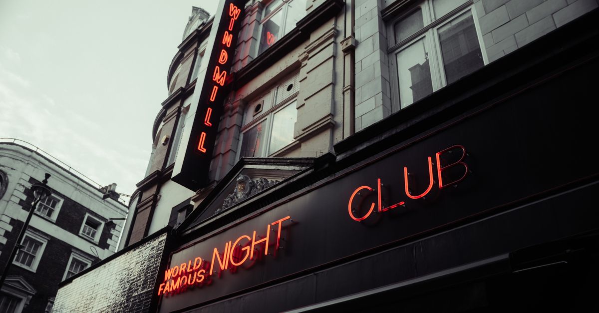 Low angle shot of the Windmill Nightclub with neon lights, London.