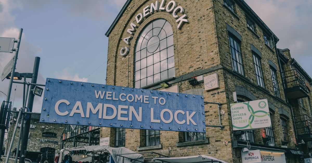 Iconic facade of Camden Lock Market in London with vibrant neighborhood scene.