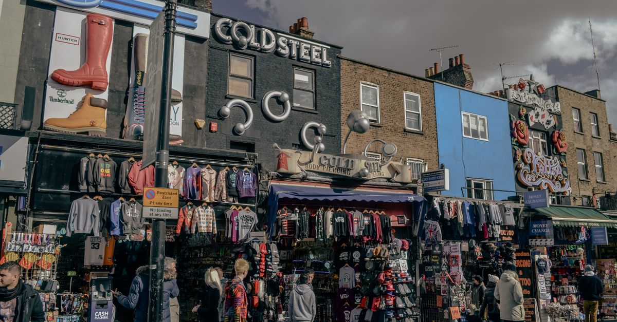 A vibrant street view of Camden Market in London showcasing quirky fashion shops and bustling activity.