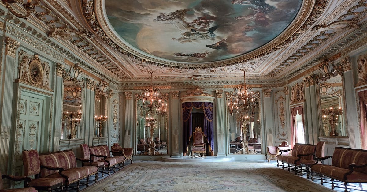 Lavishly decorated interior of a classic palace in Mumbai with ornate ceilings and chandeliers.