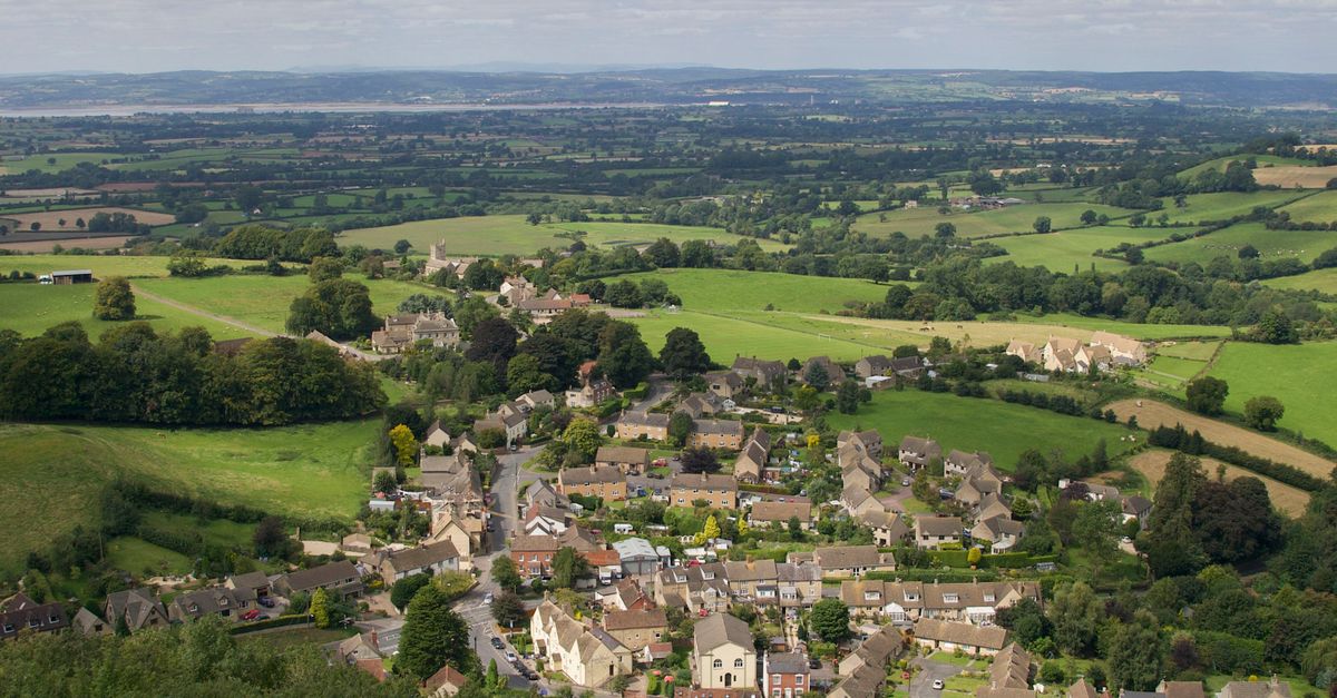 Discover the picturesque landscape of Wotton-under-Edge, England, showcasing lush fields and quaint architecture.