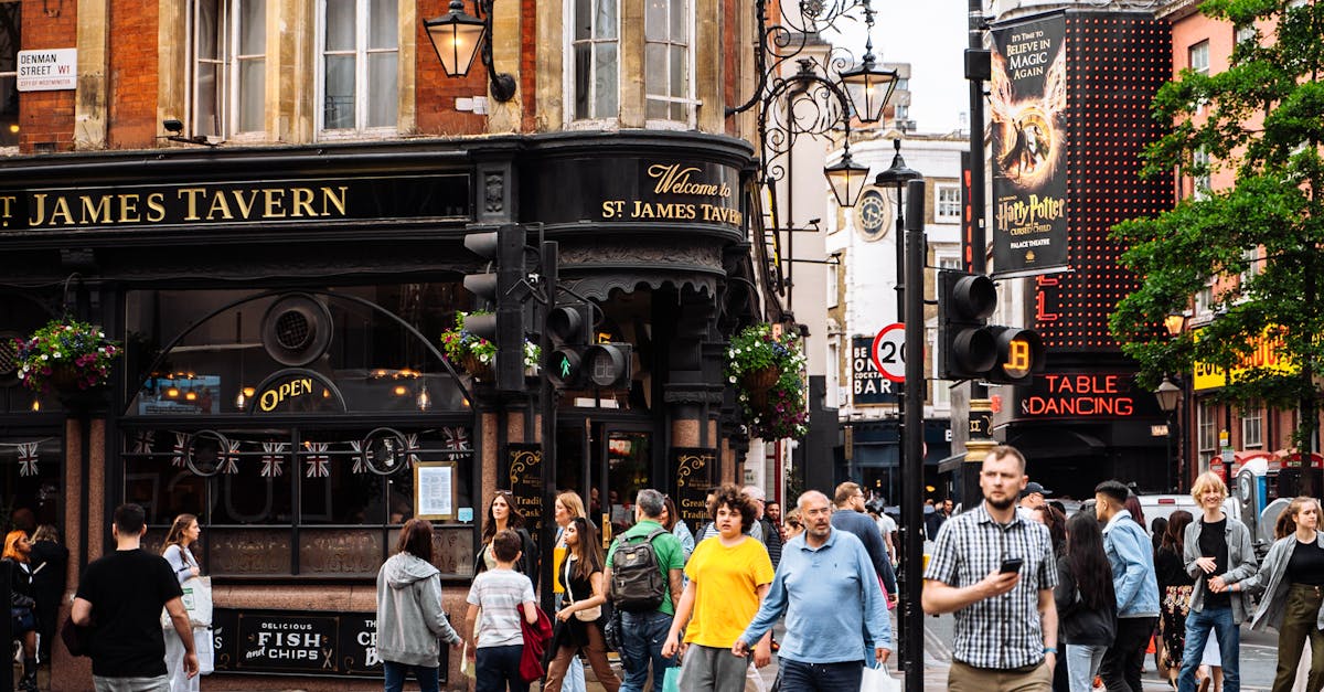 Busy street scene with pedestrians outside St. James Tavern in London, capturing the lively urban atmosphere.