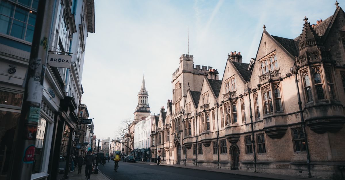 Captivating architectural view of a street in Oxford, England at sunrise, showcasing historic buildings.