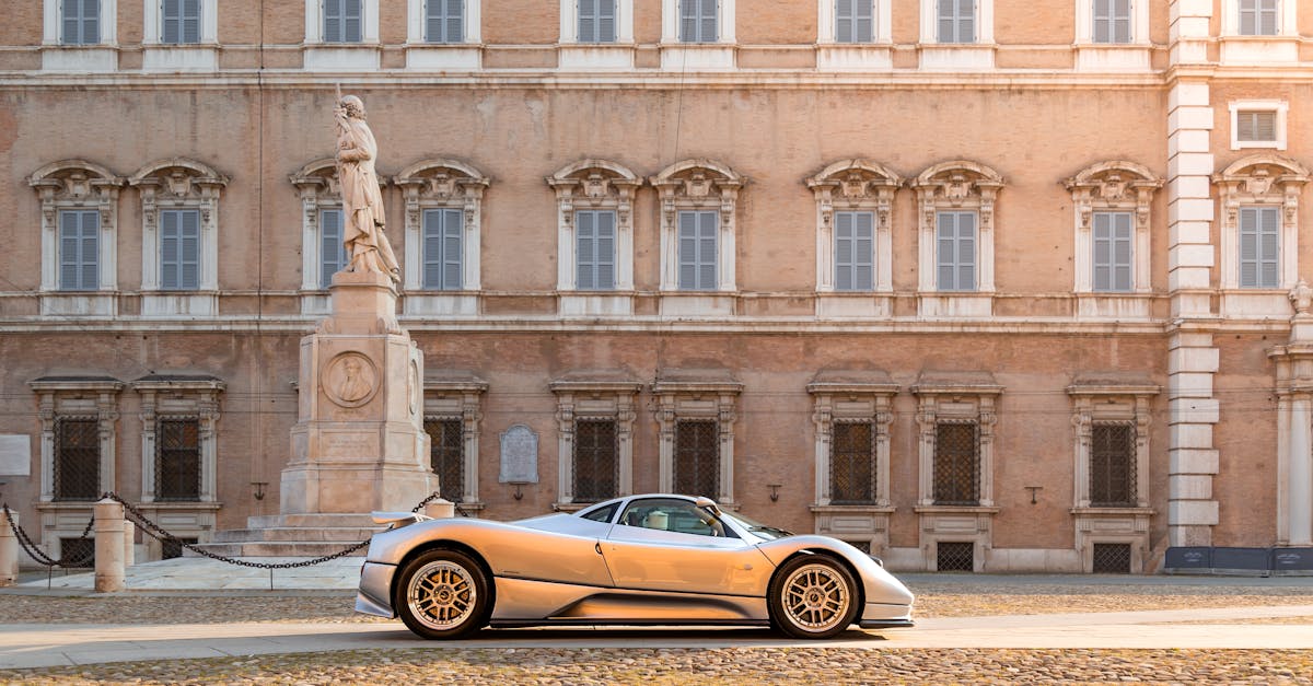 A sleek silver supercar parked in front of an ornate historic building, capturing elegance.