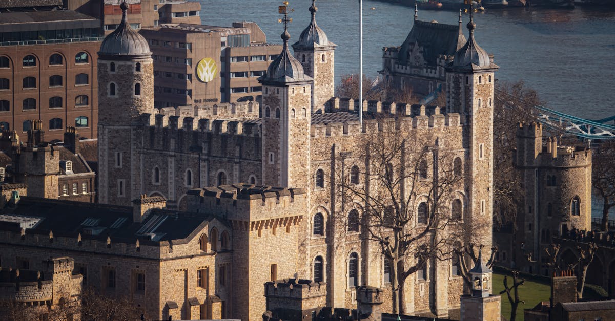 Aerial view of the iconic Tower of London beside the River Thames.
