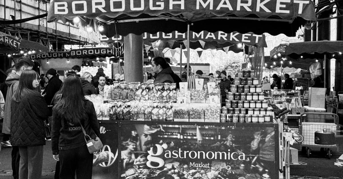 Black and white image of Borough Market's vibrant atmosphere with shoppers and stalls.