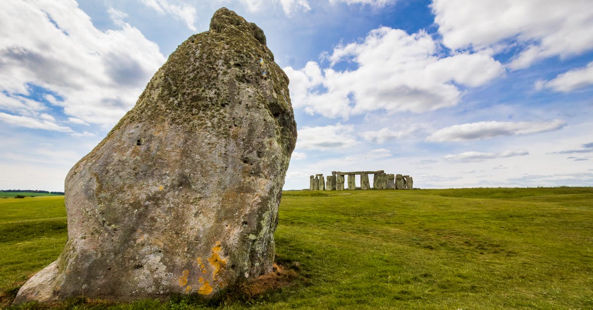 Dramatic view of Stonehenge and heelstone with a cloudy sky in Wiltshire, England.