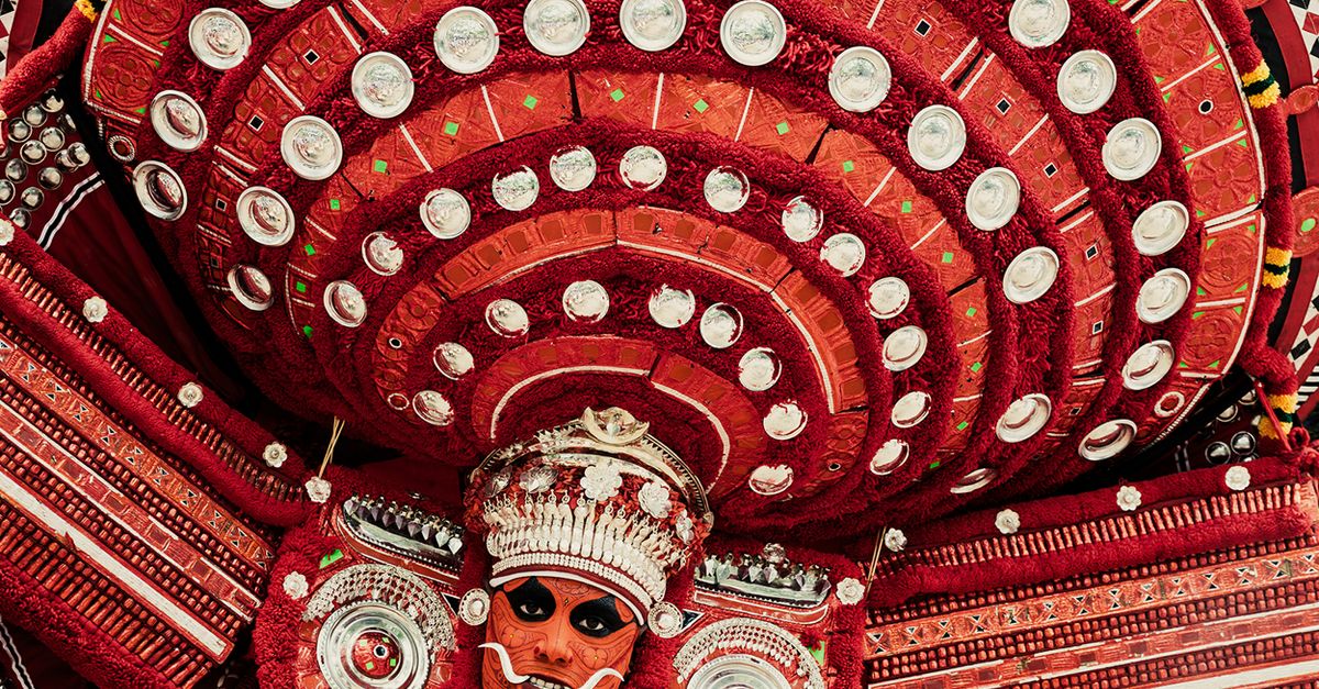 Detailed view of traditional Theyyam attire showcasing intricate designs and vivid colors.