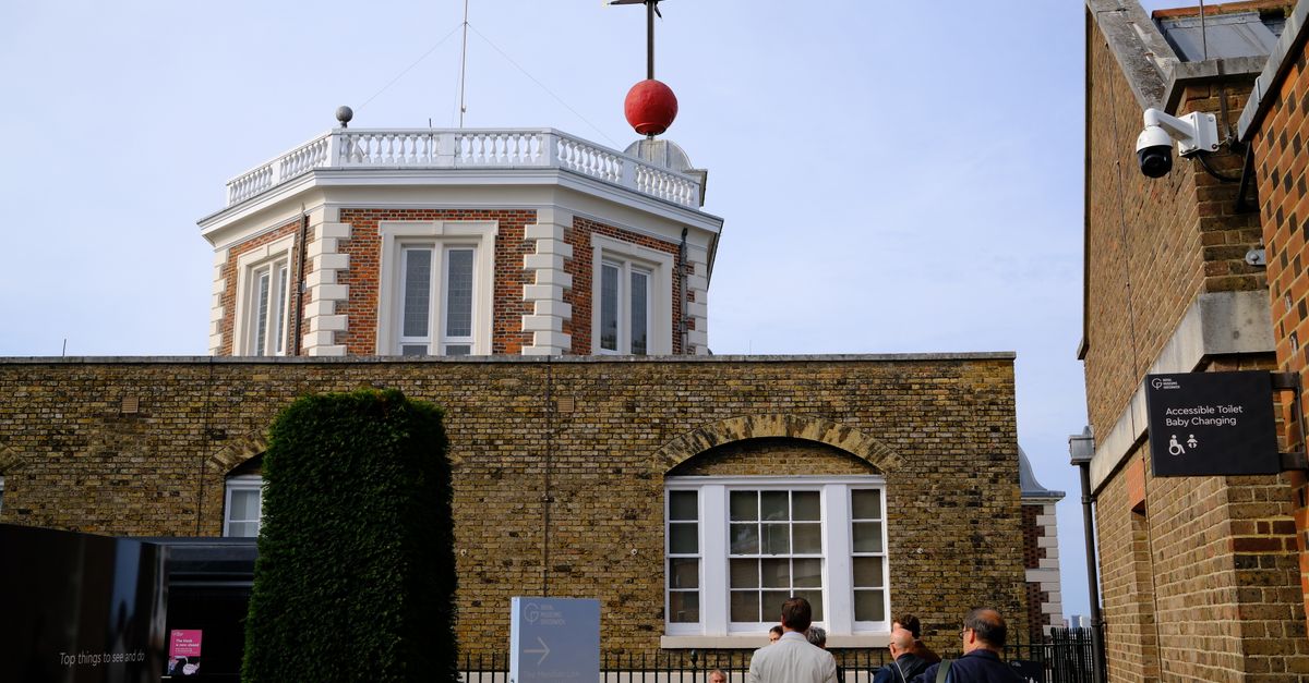 Tourists gather at the Royal Observatory in Greenwich, iconic for the Prime Meridian.