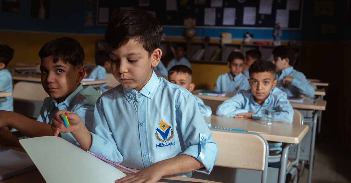 Group of boys in a classroom setting, focused on their studies in Baghdad, Iraq.