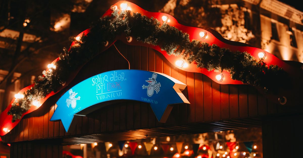Night view of a festive Christmas market entrance with lights in Baku, Azerbaijan.