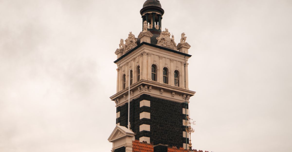 Close-up view of the historic Dunedin Railway Station tower showcasing its architectural details.