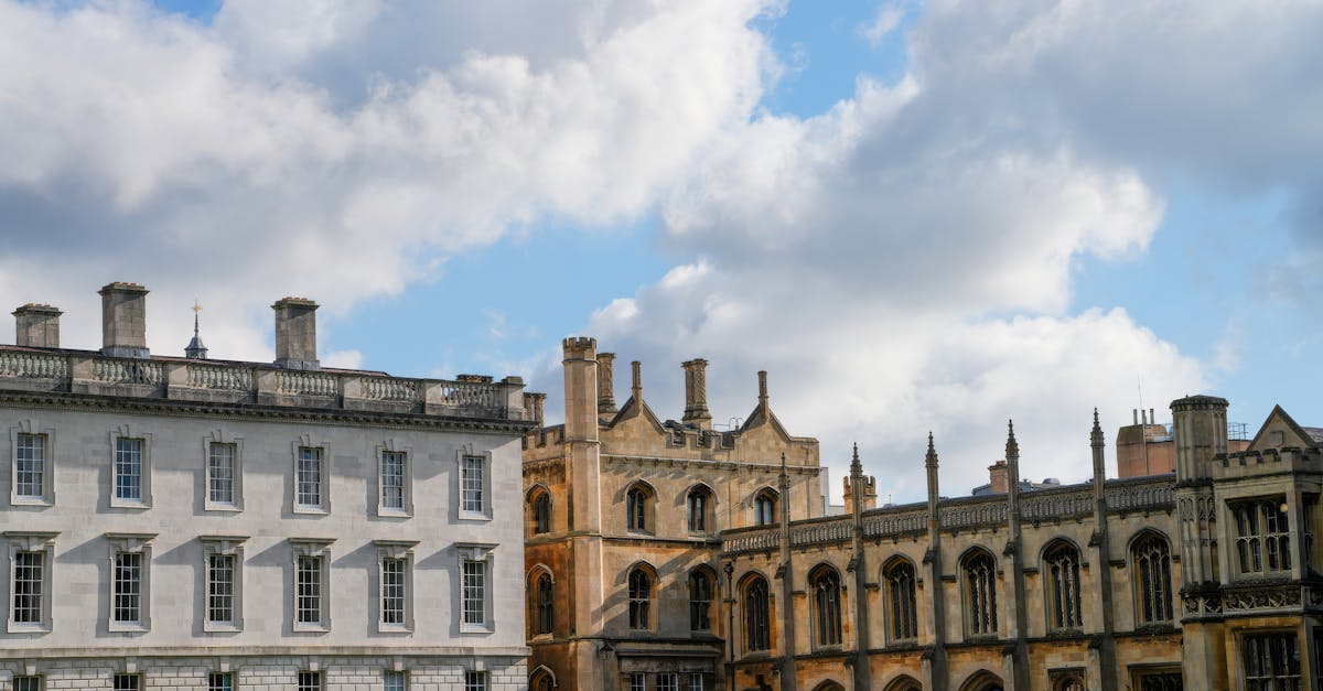 View of historic university architecture in Cambridge under a bright blue sky.