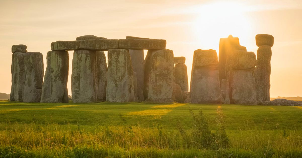 Capture of the iconic Stonehenge during sunset, highlighting its ancient structure on a serene landscape.