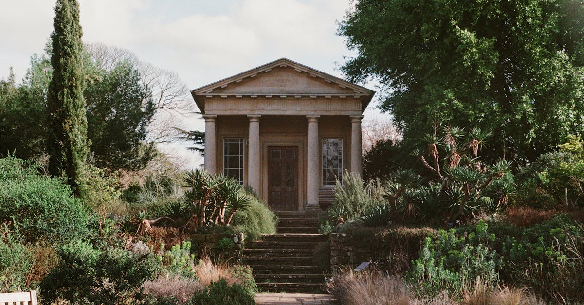 An elegant garden pavilion amidst lush greenery under a bright sky, exuding tranquility.