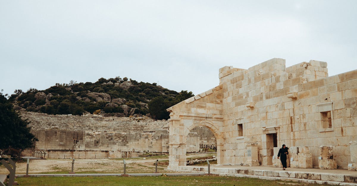 Explore the ancient stone ruins set against a lush, rocky hillside, showcasing historic architecture.