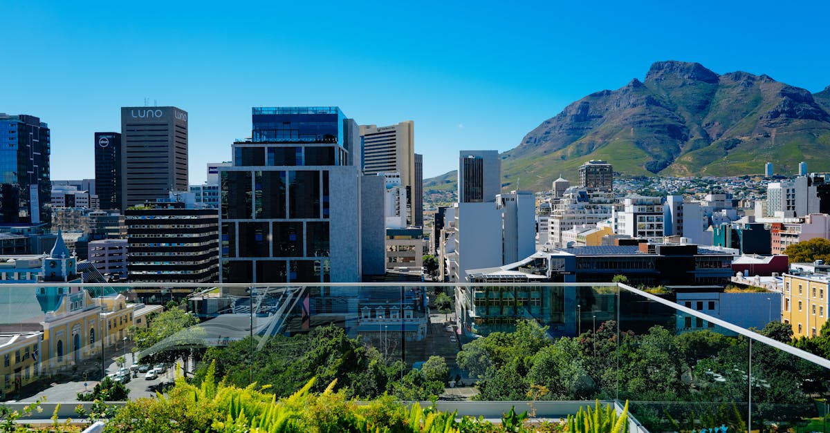 Breathtaking rooftop view of Cape Town's skyline with Table Mountain in the background under a clear blue sky.