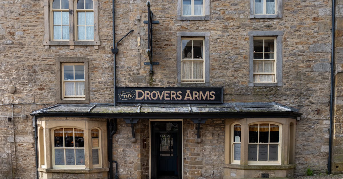 Facade of The Drovers Arms pub in Grassington, England, showing classic stone architecture.