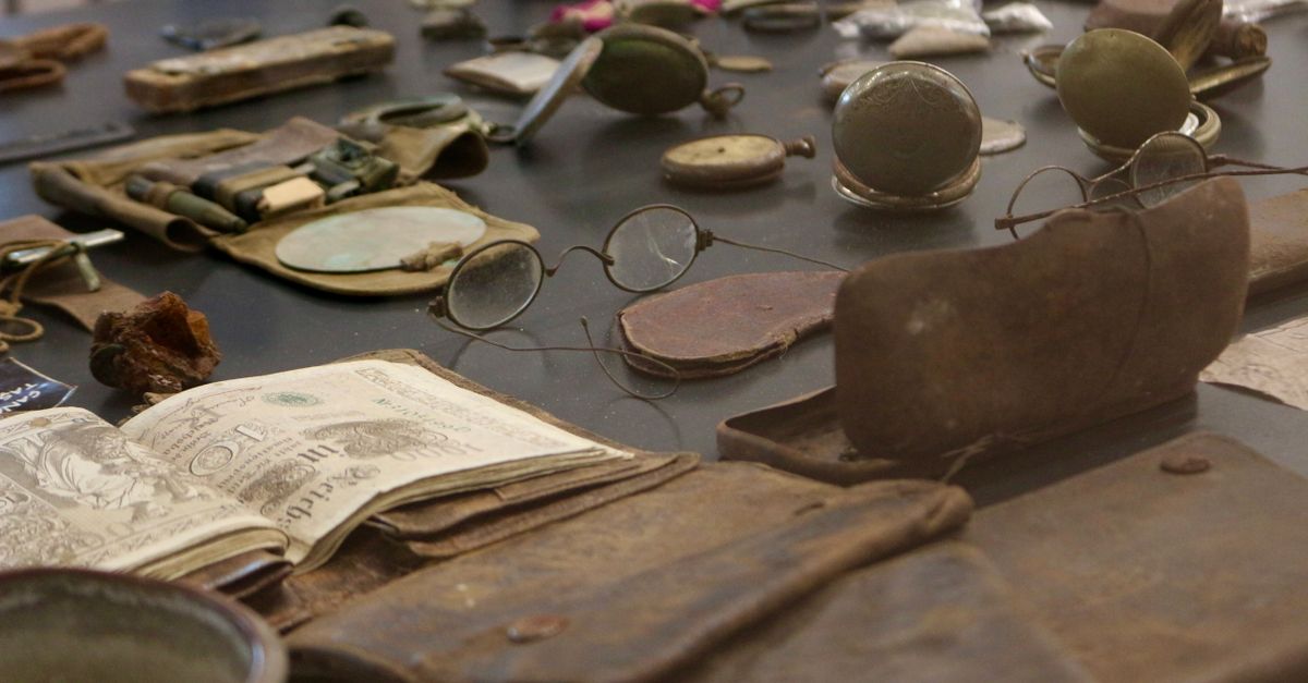 A detailed view of antique artifacts including glasses and documents on display.