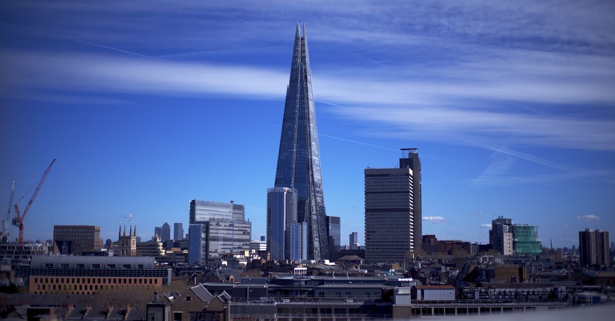 A breathtaking view of The Shard and London skyline under a clear blue sky.