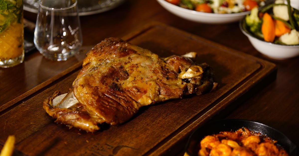 A mouthwatering grilled lamb dish served with vegetables and sauces, perfect for a gourmet feast.
