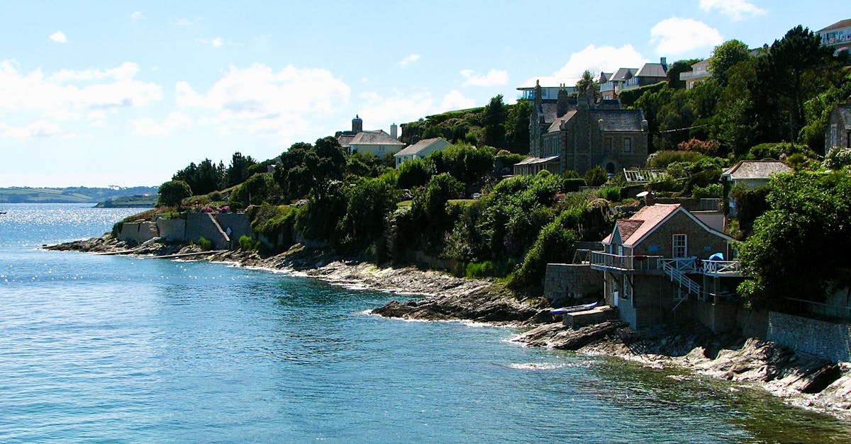 Peaceful coastal landscape in England with blue waters and coastal houses.