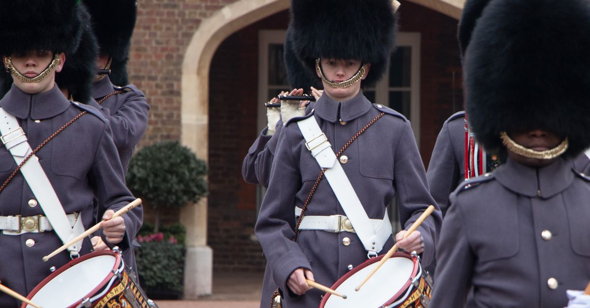 Guards in traditional attire perform at a London changing of the guard ceremony.