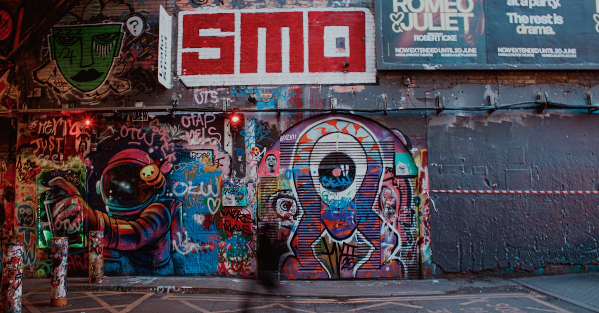 Colorful graffiti mural with street art in an urban city alleyway at night.