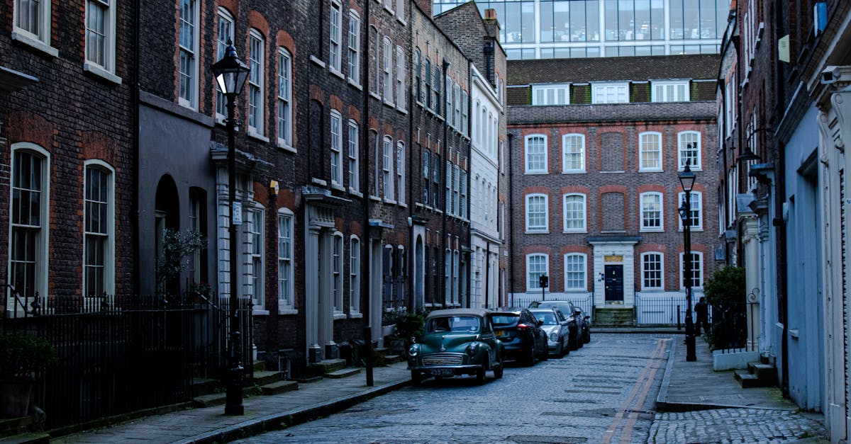 Quaint London street scene featuring historic brick buildings and parked cars, capturing urban charm and architectural elegance.